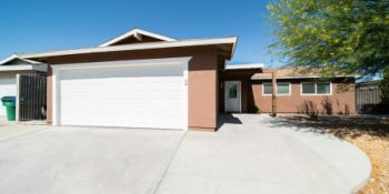 Suburban home with wide concrete driveway improving the curb appeal of the home and neighbourhood